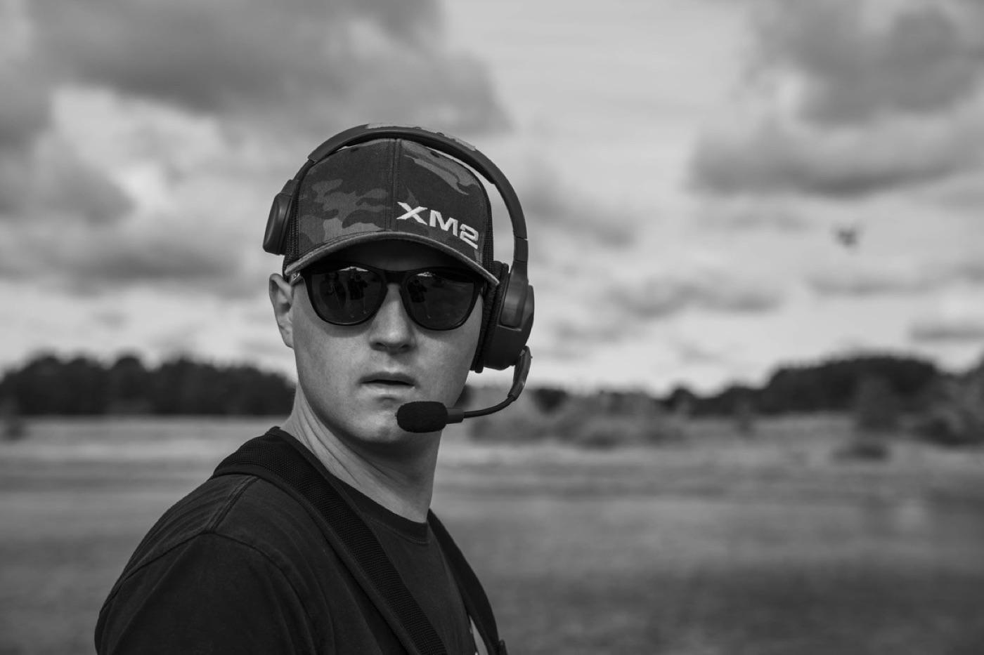 Black and white portrait of Jan Urbański wearing an XM2 cap and aviation headset